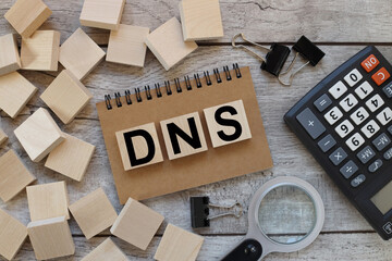 DNS. text on wooden cubes. cubes on a notebook near a black calculator
