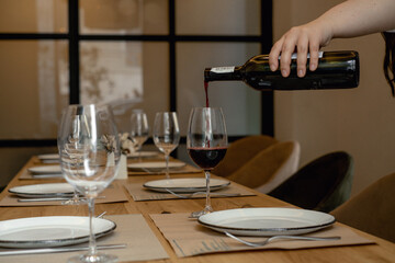 pour red wine into a glass