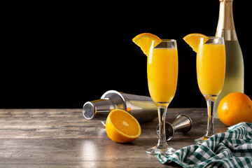 Orange mimosa cocktail on wooden table.Copy space