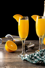 Orange mimosa cocktail on wooden table	
