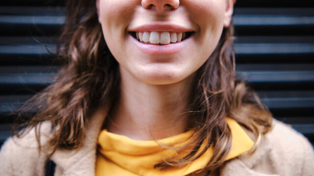 Young woman smiling near shutter