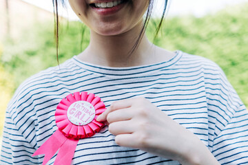 Smiling woman showing birthday broach