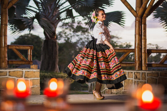 Dancer: Beautiful Latin woman in a colorful dress. typical Colombian dance costume. Cultural heritages today. Latin American roots and cultures. Multicultural ethnic diversity	
