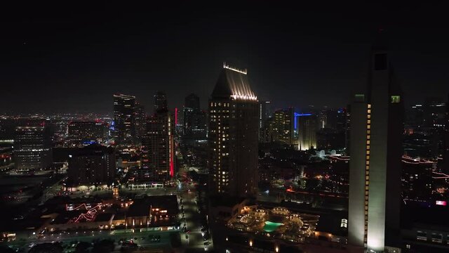 illuminated tall buildings in San Diego nightscape, California, USA. aerial panning view
