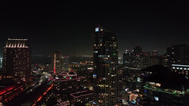 high-rise apartment buildings at downtown of San Diego city, California, at night. drone descending view