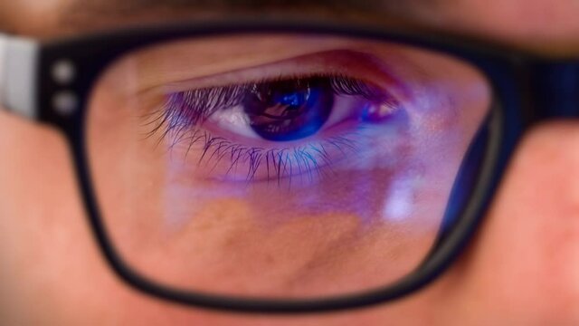 
Young Man Eye Glasses Reflection. Caucasian Male Looking at Electronic Device with Animated Videos Reflected in his Eyeglasses. All Videos Included in my Portfolio.