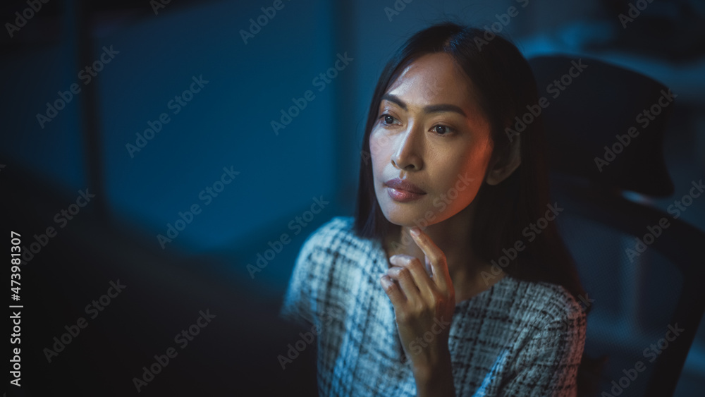 Poster portrait of a financial analyst working on computer with multi-monitor workstation with real-time st
