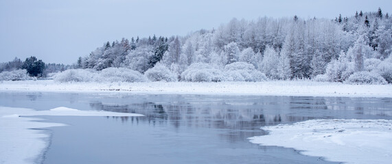 River in a cold winter landscape with snow and frost