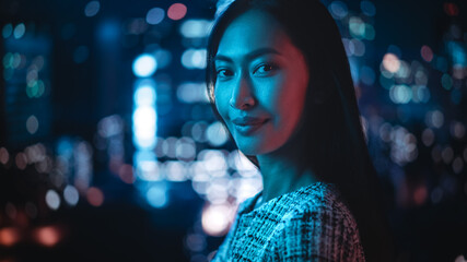 Beautiful Asian Female Portrait Standing on City Street with Neon Lights Late in the Evening....