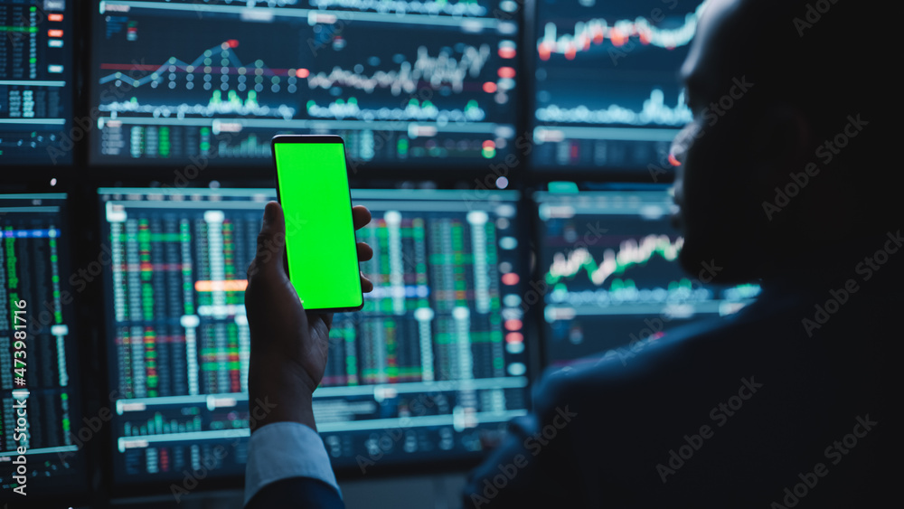 Poster financial analyst using smartphone with green screen chroma key mock up template and working on mult