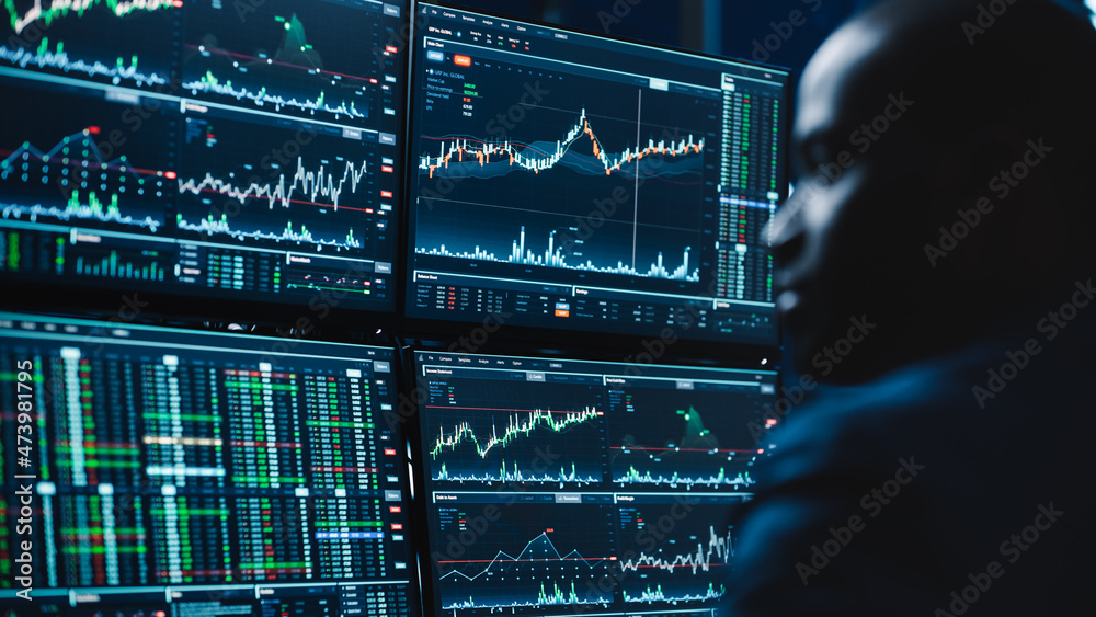 Poster close up portrait of financial analyst working on computer with multi-monitor workstation with real-
