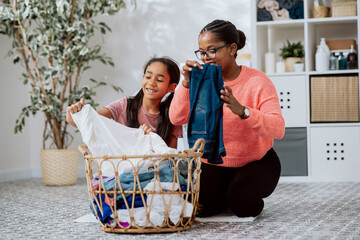 The daughter helps mother with household chores, the women sort laundry, fold clothes, prepare them...