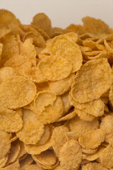 pile of cereal corn flakes background close up filled frame copy space wallpaper vertical shot
