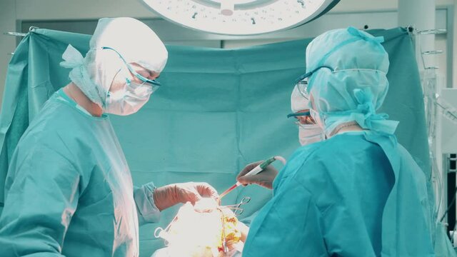 Group of doctors are performing an orthopedic surgery