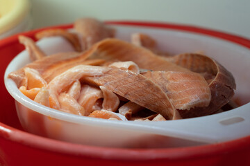 Remains of red fish after processing for sushi in a professional kitchen.