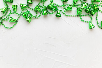 Green Christmas bells on white putty background. Bright garland. Holiday decoration. New Year,...