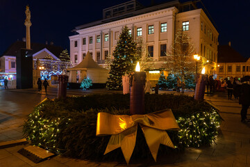 advent wreath on christmas market in Gyor Hungary with lights and people
