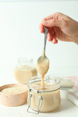 Concept of tasty food with tahini sauce on white table