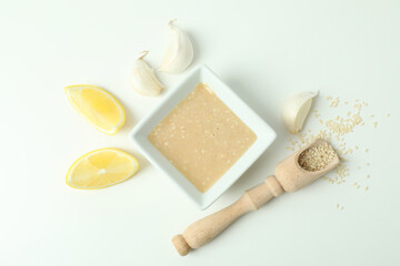 Concept of tasty food with tahini sauce on white background