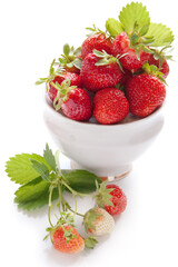 Fresh garden strawberry with green leaf in the white bowl
