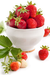 Fresh garden strawberry with green leaf in the white bowl