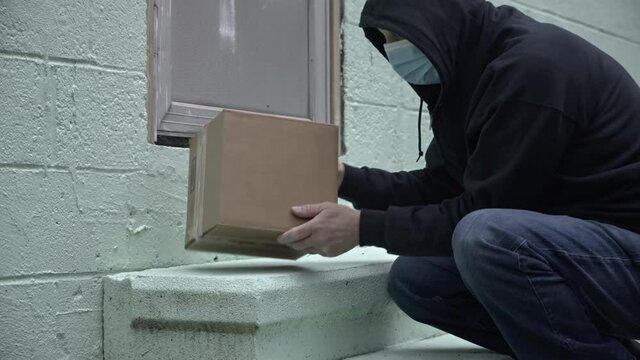Conceptual video from man stealing package with other box delivered to front door