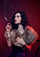 Retro burlesque diva with tattoes smoking a cigarette.