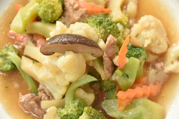 stir fried Cauliflower and broccoli with mushroom in oyster sauce on plate