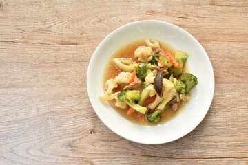 stir fried Cauliflower and broccoli with mushroom in oyster sauce on plate