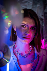 Cinematic night portrait of girl and neon lights. Fashion. Woman in Colorful neon light. girl in disco, makeup dance. Party disco neon nightclub vibes. creative art neon pink blue light.