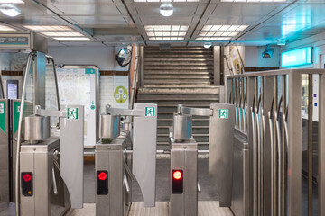Fare gates in an underground metro station in Paris France - 473988524