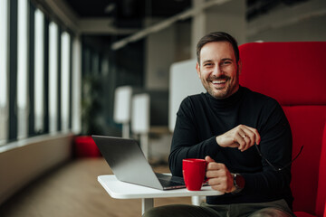 Portrait of a delighted caucasian man, taking his glasses off for a short break.
