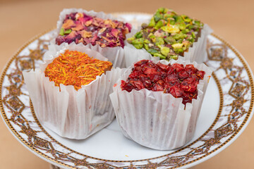 Four cubes of fruit delight of different tastes on a saucer, traditional oriental sweet