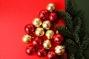 Christmas background decorated with red ornaments. New year greeting card with bauble hanging. Banner