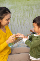 Fototapeta premium a mother uses antiseptics for her son