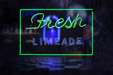 Neon Fresh Limeade Sign in Rainy Window