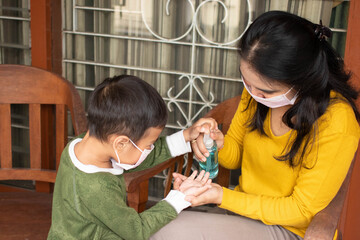 a mother uses antiseptics for her son at home