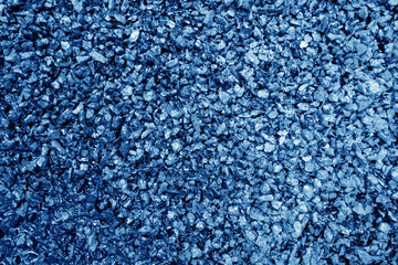 Asphalt road closeup in navy blue tone.