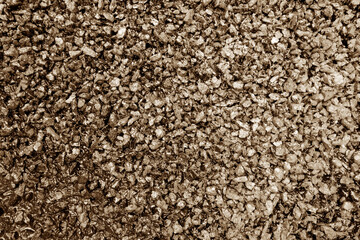 Asphalt road closeup in brown tone.