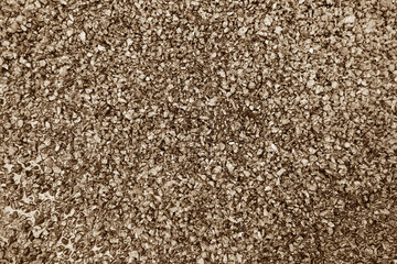 Asphalt road closeup in brown tone.