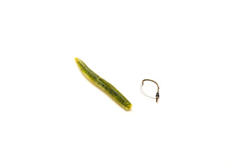 One green pumpkin plastic worm with weedless bait holder hook isolated on white background