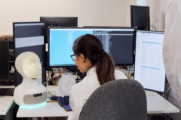 Female engineer working on robot