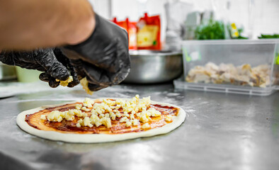 hand of chef baker making pizza at kitchen. The process of making pizza. cooking italian pizza