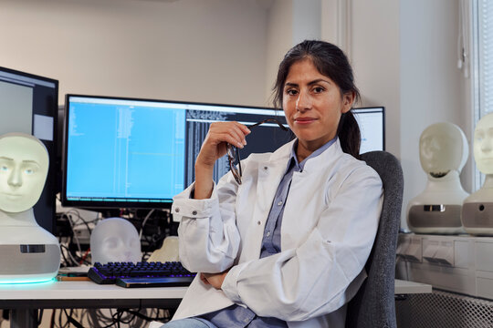 Portrait of female engineer at work station