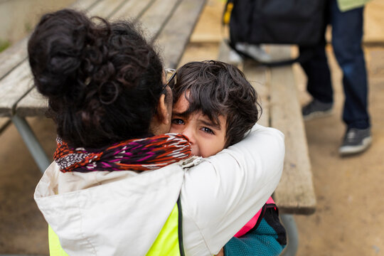 Preschool Teacher Hugging Crying Student