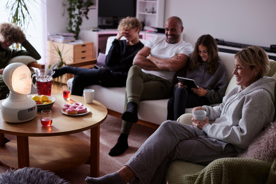 Family with children sitting on sofa in living room