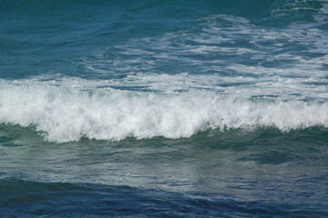 A stormy surface with waves of the sea and bubbles