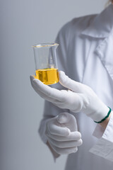 Chemical test tubes and flasks with petroleum products, safety glasses white gloves