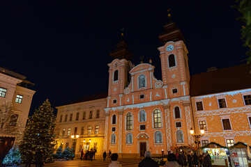 Naklejka na ściany i meble christmas market in Gyor Hungary with lights and people