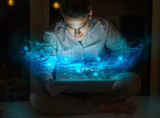 Young male professional using laptop at home office
